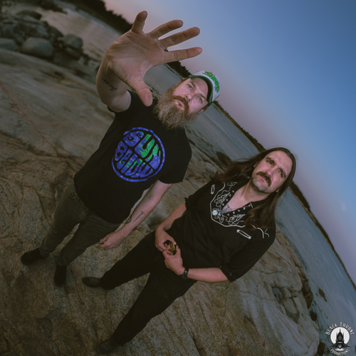 Image of Earth Altar - a ONE on Stage band. Two people standingo n beach.