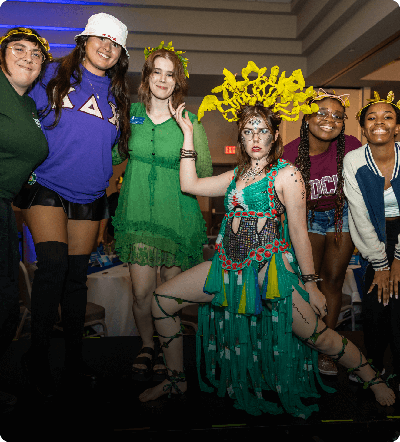 Group of people in costumes posing together at an event.
