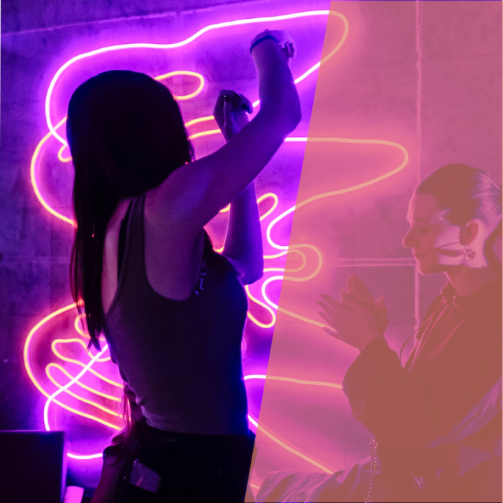 A person dancing in front of a neon background.