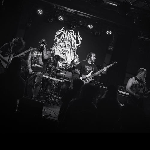 Band performing on stage with a large logo in the background