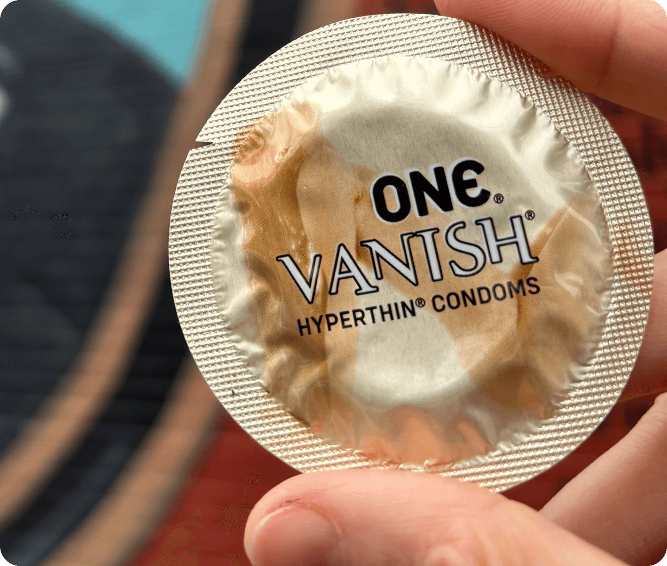 one condom gold vanish hyperthin wrapper being held up