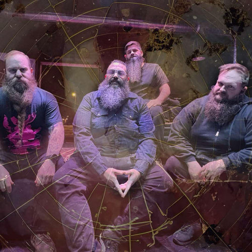 Four men with beards sitting together in a casual setting.