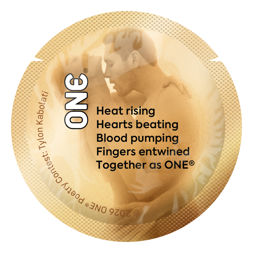Gold condom wrapper with poetry winner - Heat rising, Hearts beating, Blood pumping, Fingers entwined, Together as ONE®.