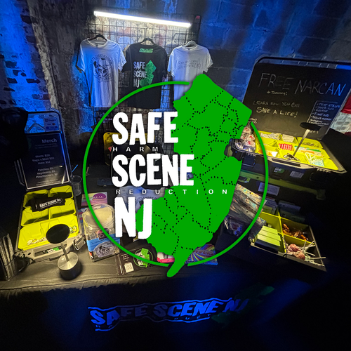 Display with 'Safe Scene NJ' branding and various items on a table.