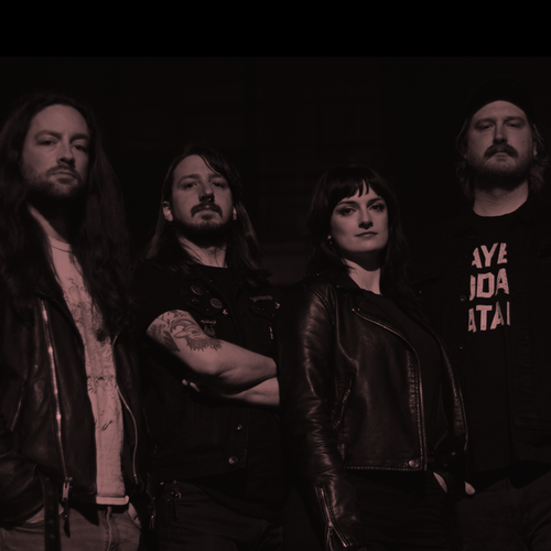 Image of Slow Goat - a new ONE on Stage band. Four people dressed in black looking at camera.